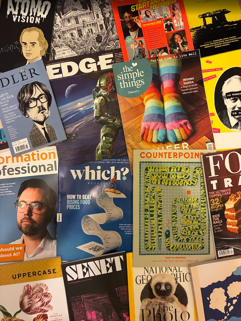 A scattered assortment of magazines, including National Geographic, Senet, Idler, and (best of all) Atomovision.