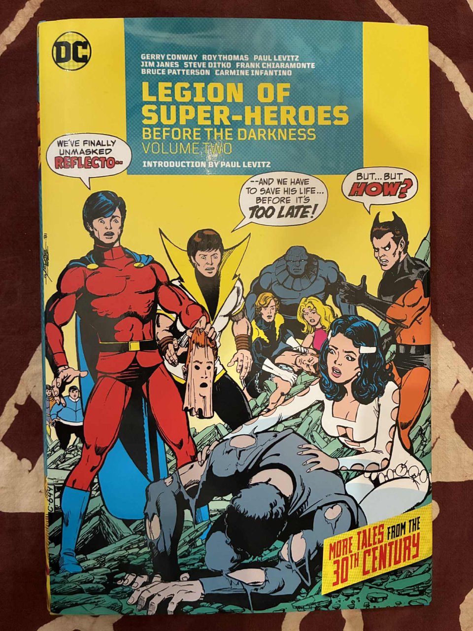 Cover of The Legion of Super-Heroes: Before the Darkness volume 2, featuring a variety of colorful costumed characters against a bright yellow background and a sensible title font.