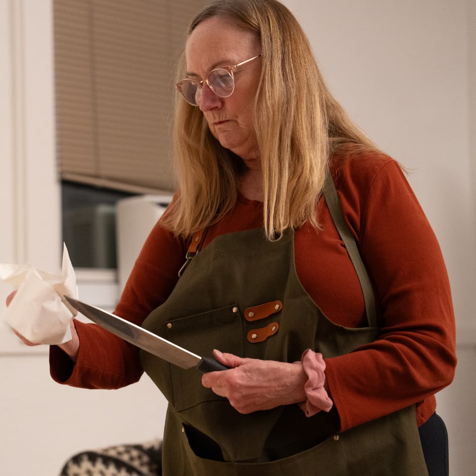 Mary Ann Tate cleaning off a knife.