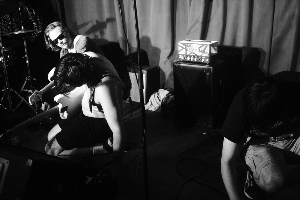 the band TV Sleep all kneeling down to play noisy freakouts on their pedalboards.