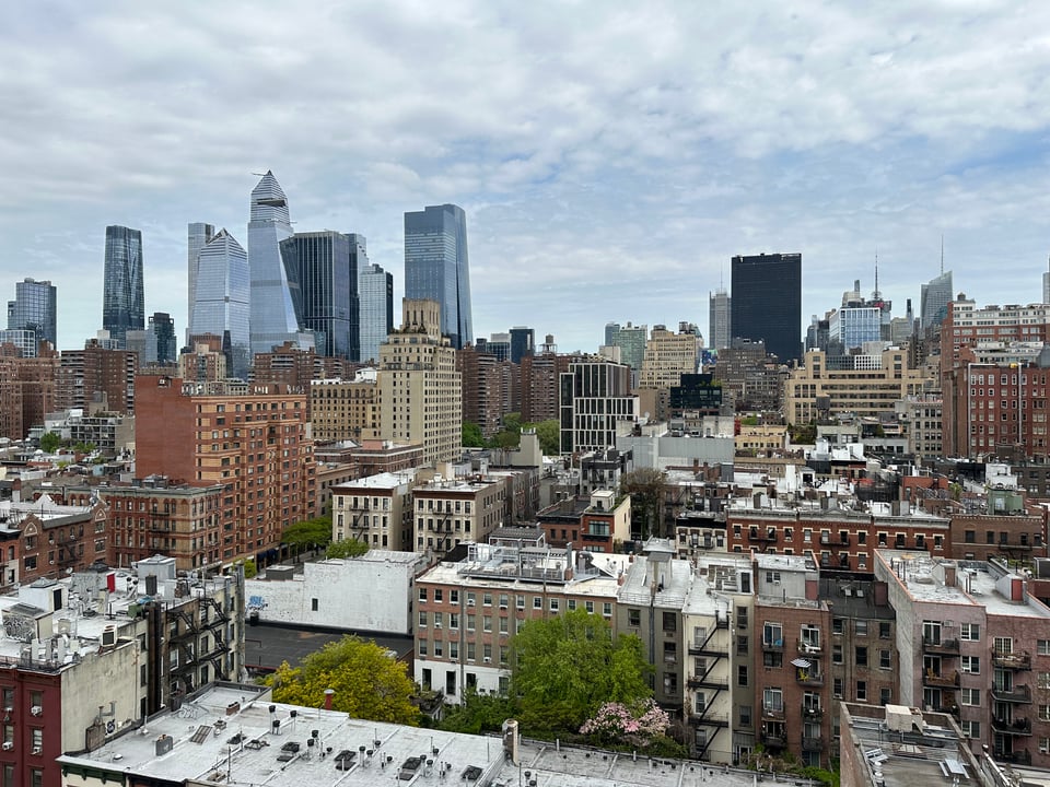 Photo of cityscape of NYC, looking NNW from 19th St.; brick buildings in the foreground, and the steel/glass towers of Hudson Yards in the background