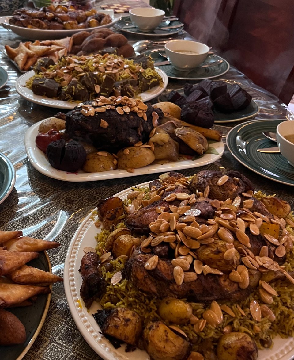 A table set with various plates of piles of food