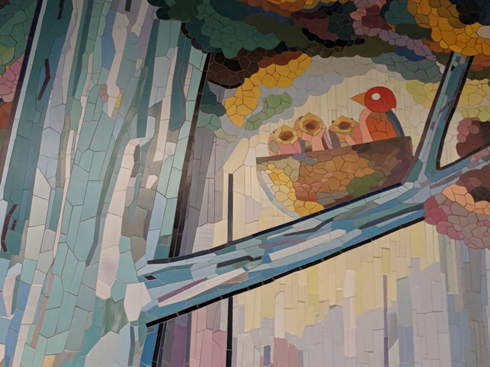 Some gorgeous mosaic-style art showing a bird and her baby birds
