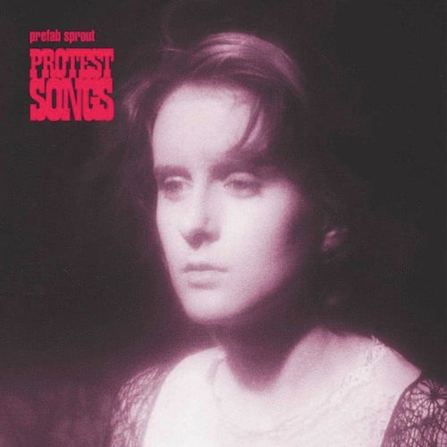 A red-tinged monotone photograph of a person that I think is Wendy Smith of Prefab Sprout but not absolutely sure. The photo is from the shoulders up, and she is wearing a lacy, kind of old fashioned dress. She looks off to the left, a bit distant, a bit sad.