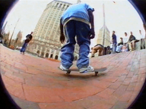 An animated gif of a skateboarder doing a "flip" that launches the skateboard into the air as they rise over it, with the skateboard doing a 360 twist beneath them, and them landing on it again