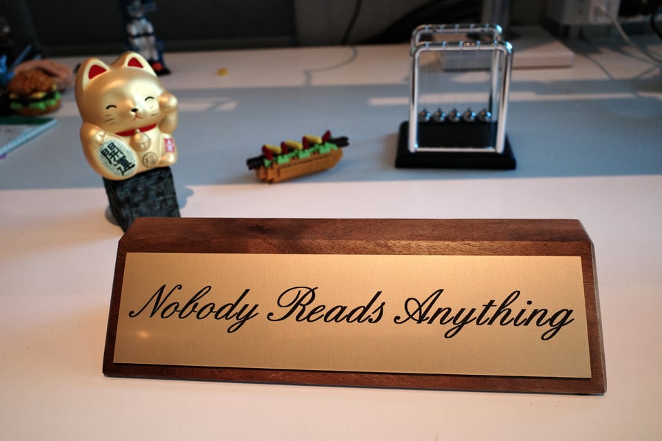 A plaque that reads, "Nobody Reads Anything"