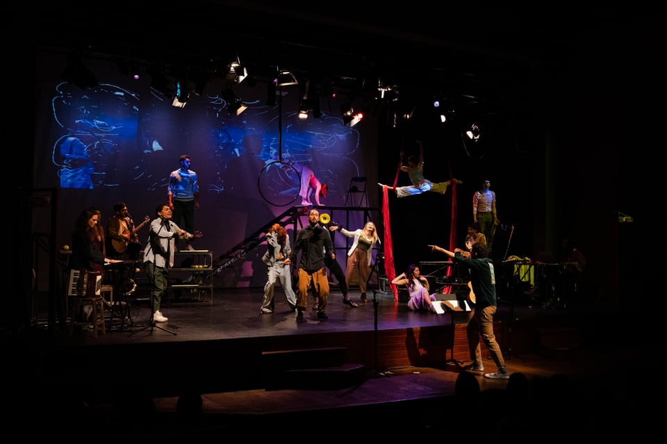 a stage with actors, musicians, dancers, circus artists