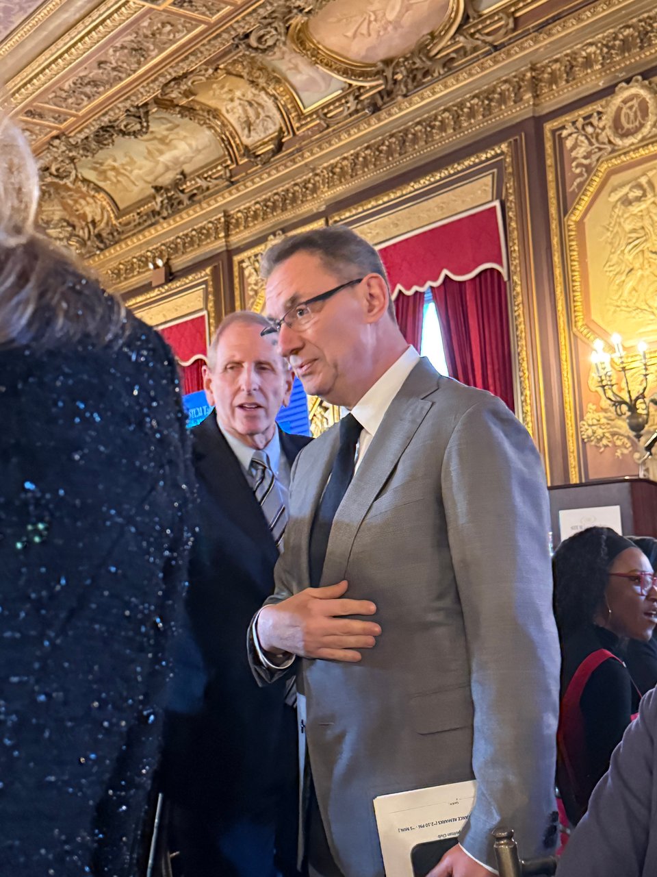 Photo of Pfizer CEO Albert Bourla in a dining room at the Metropolitan club in NYC.