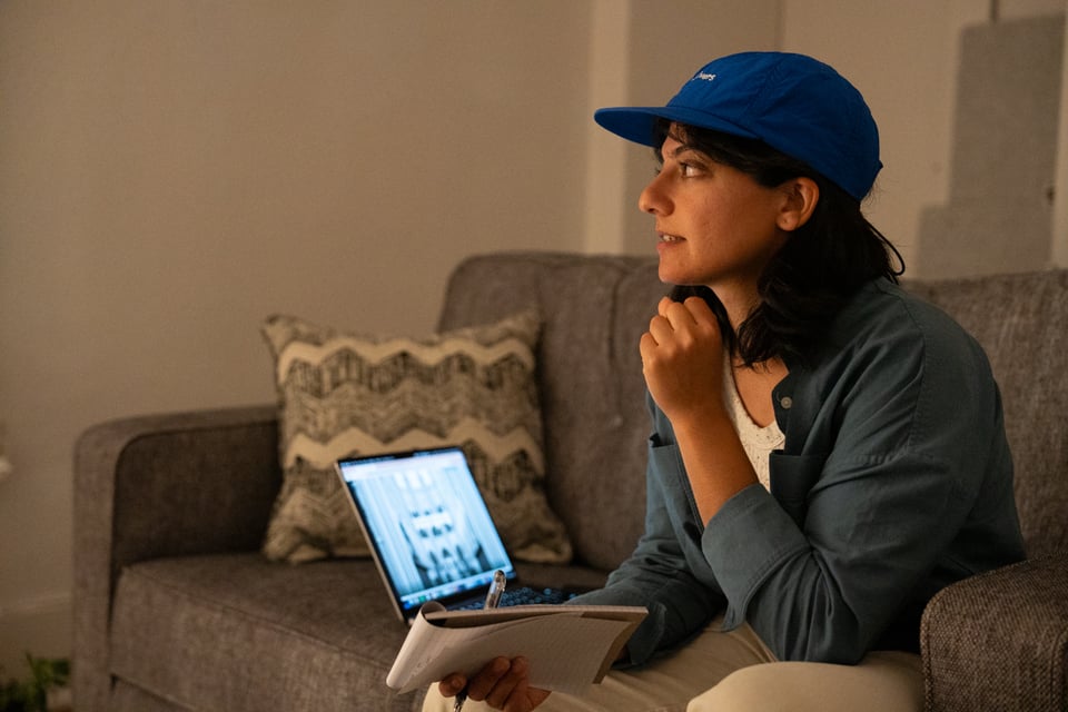 A lovely human being holds a notebook as if she’s a reporter.