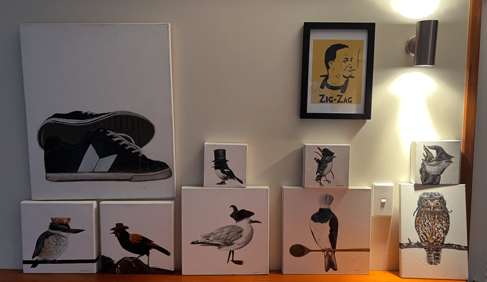A photo of paintings of birds wearing hats