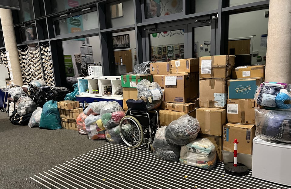 A pile of cartons, bags and other items ready to load onto vans for shipment to Ukraine