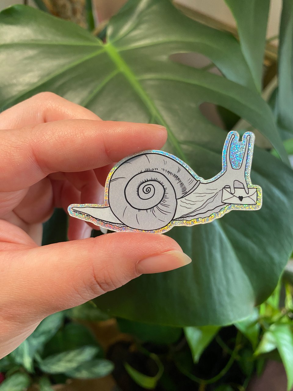 snail illustration sticker with glitter border.
