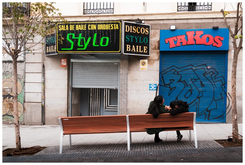 two people sitting on a bench