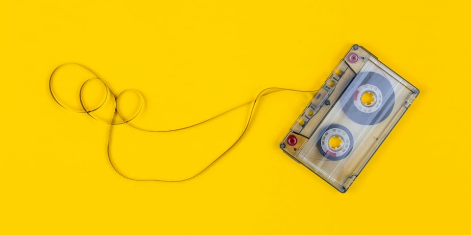 A cassette tape on a yellow background.