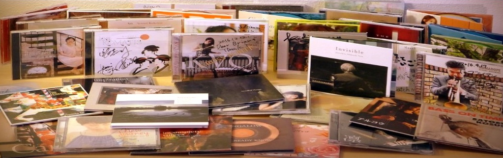 Dozens of Japanese jazz CDs on a table