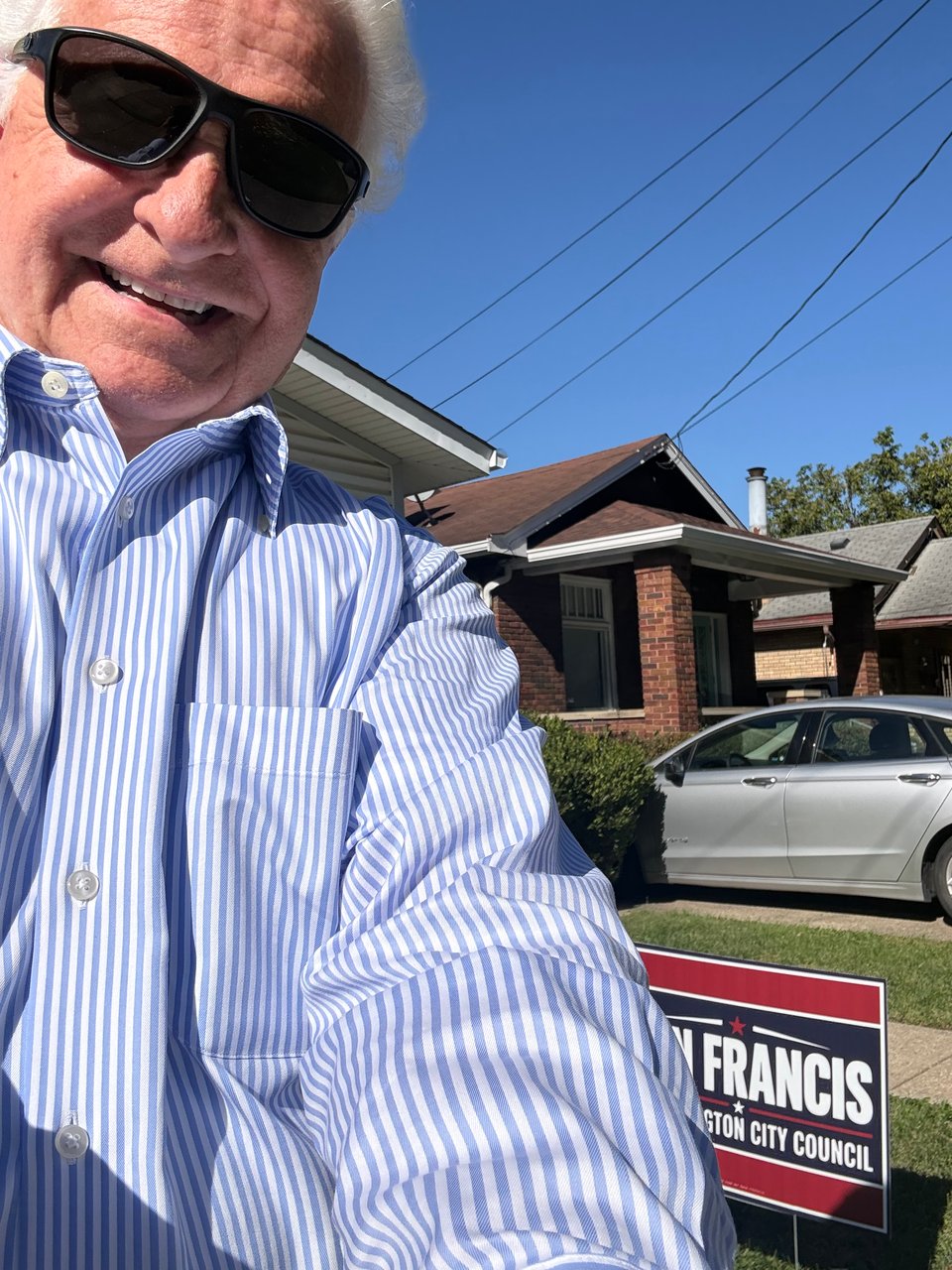 Picture of me and my city council sign in front of Doris Howard's home