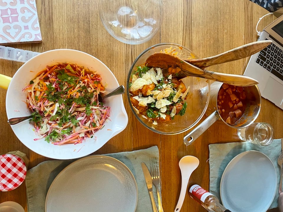 Coleslaw, potato salad and chickpea stew lined up on a dining table