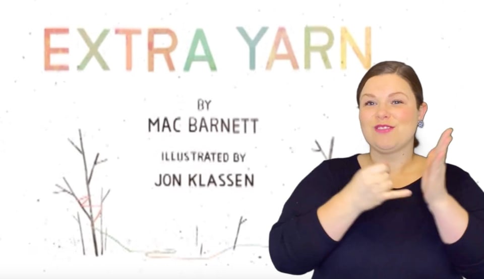 Image: Deaf educator Jenni Jackerson signs the word ILLUSTRATOR or ARTIST in ASL. She is superimposed over the title sequence for the animated version of Extra Yarn. Text: Extra Yarn by Mac Barnett, illustrated by Jon Klassen
