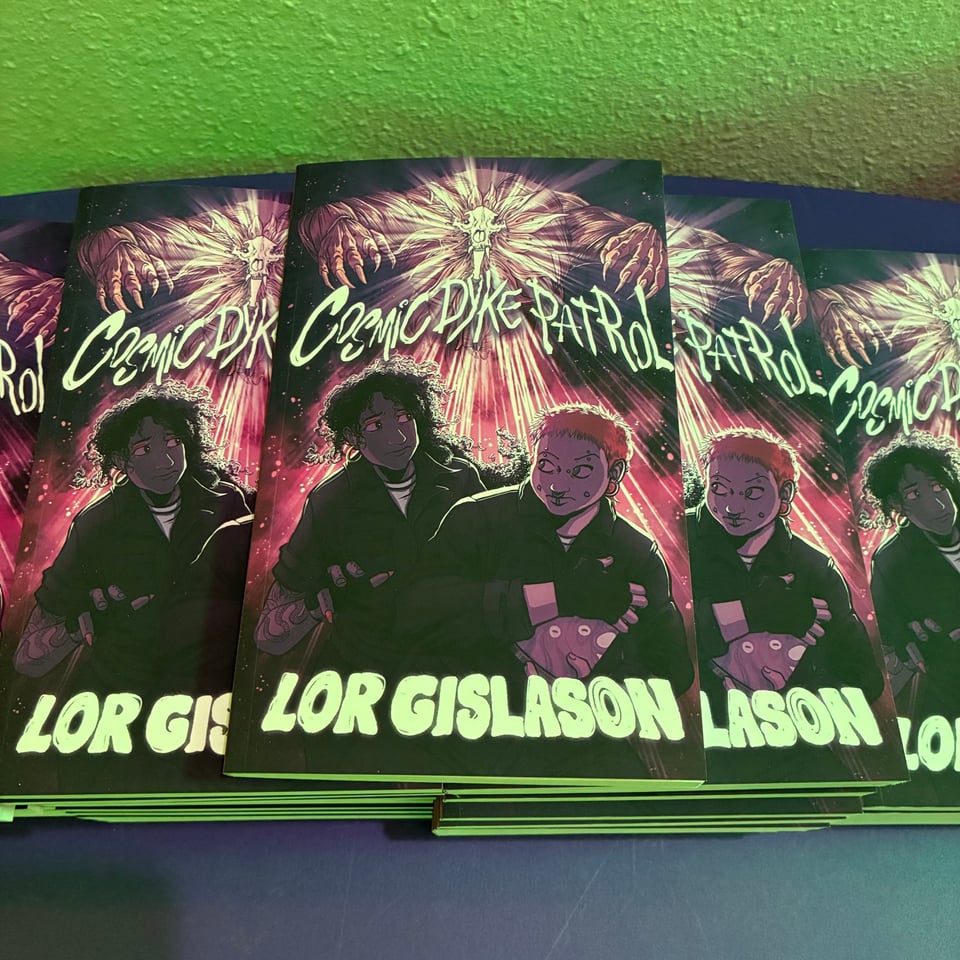 a stack of paperbacks of cosmic dyke patrol