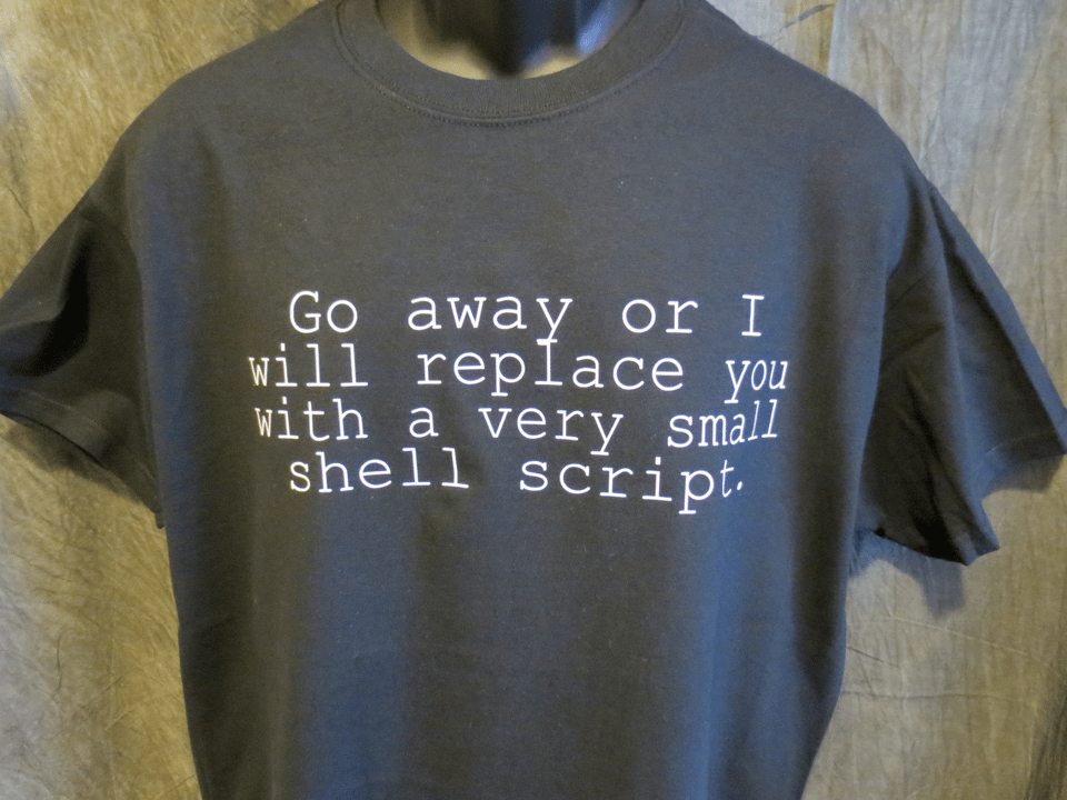 Black T-shirt with classic motto, "Go away or I will replace you with a very small shell script."