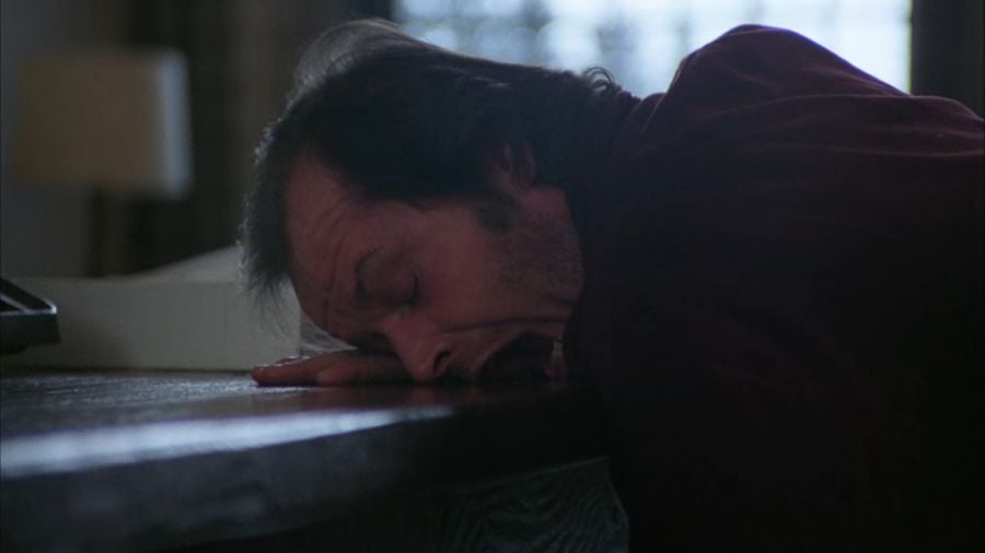Jack Torrance asleep at his writing desk with his mouth wide open, mid-scream.