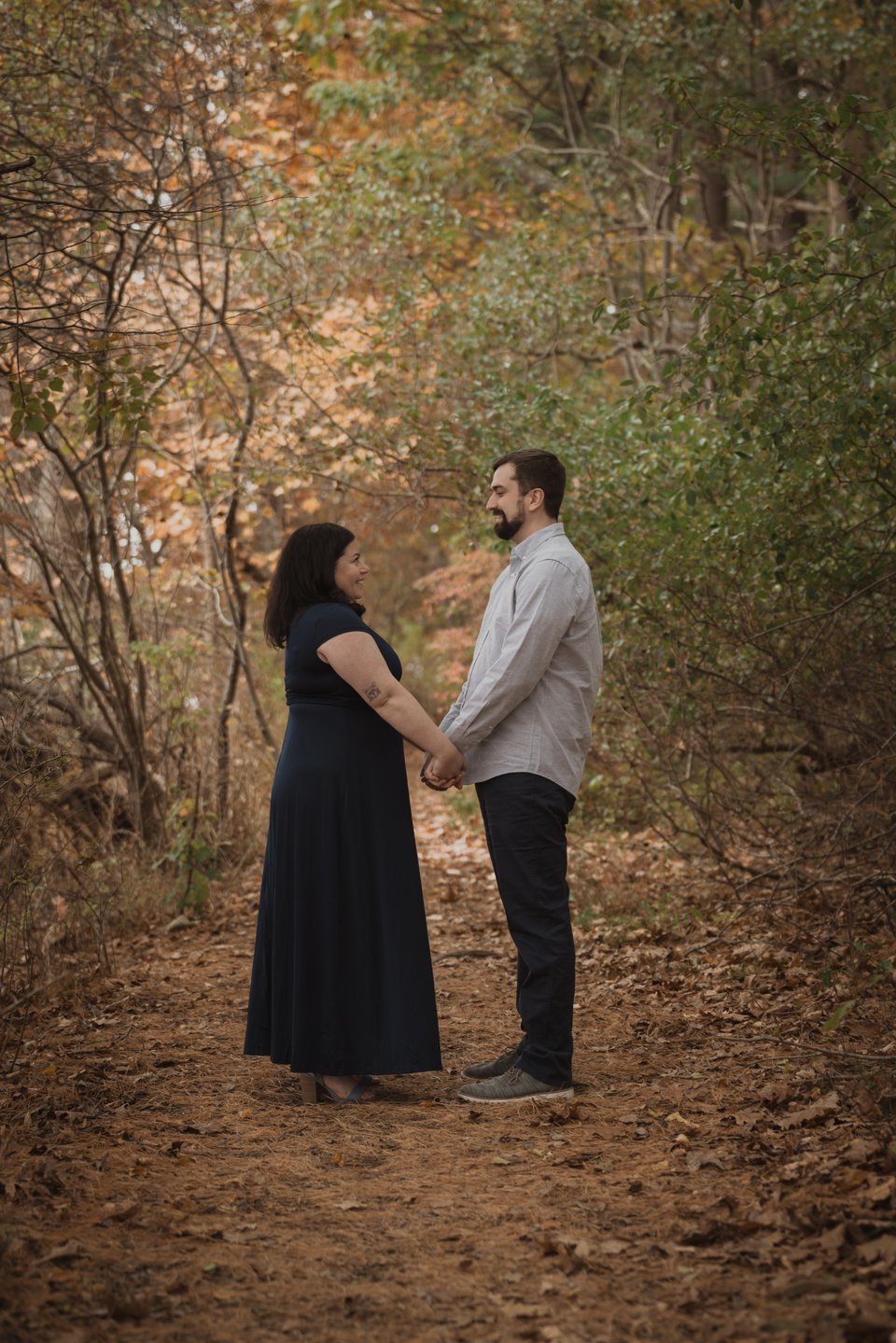an engaged couple in the woods