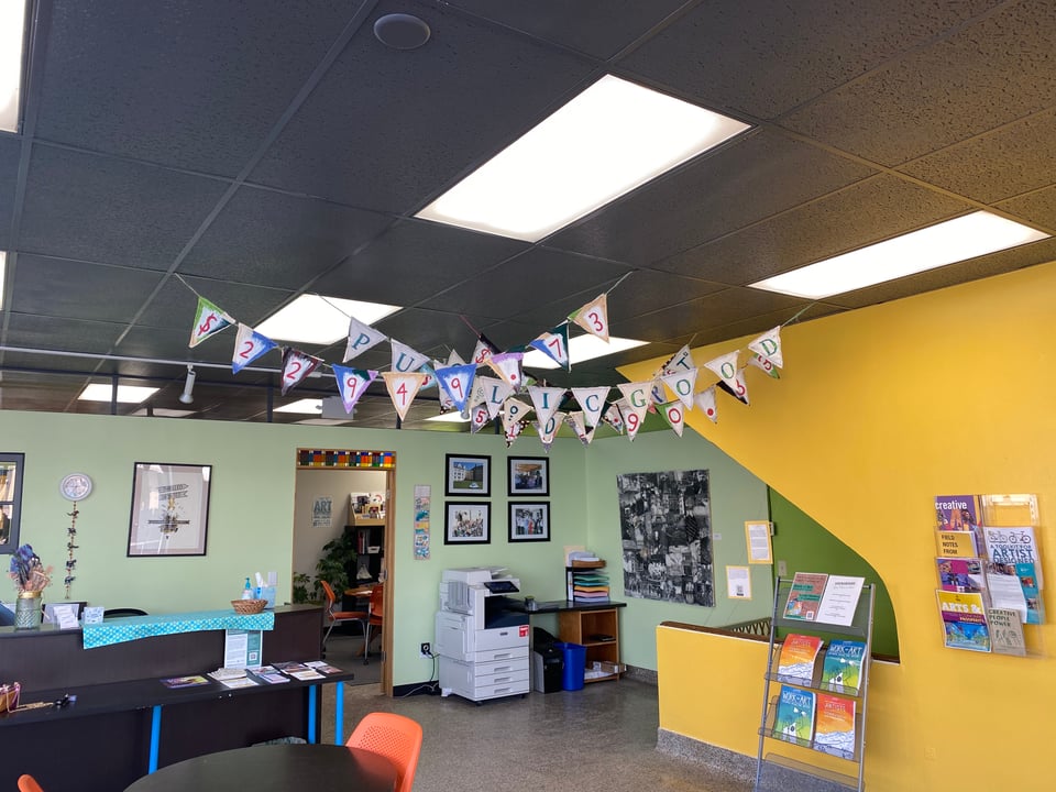 interior installation view of banners hanging in office space