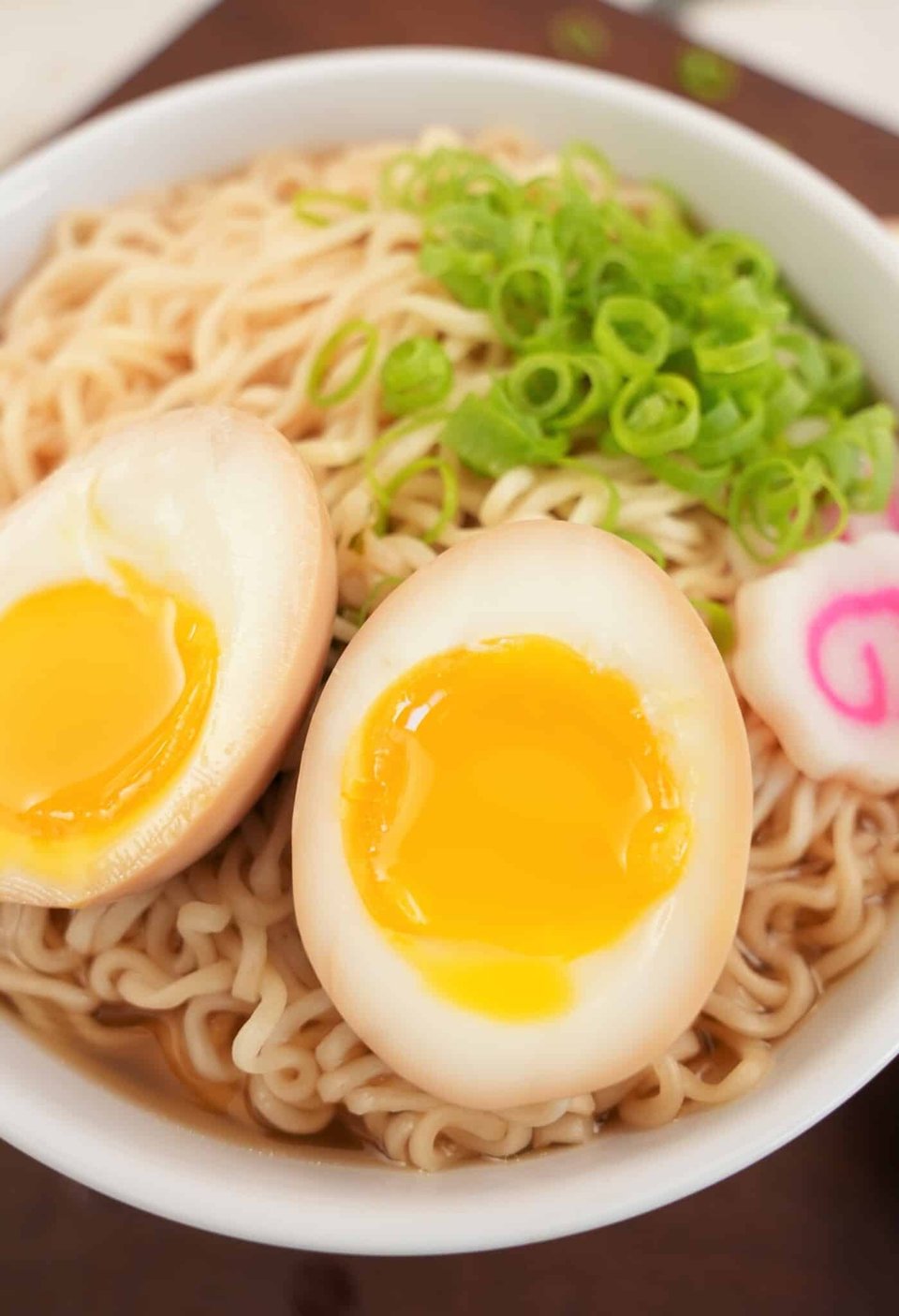 Halved boiled egg over a bowl of ramen.