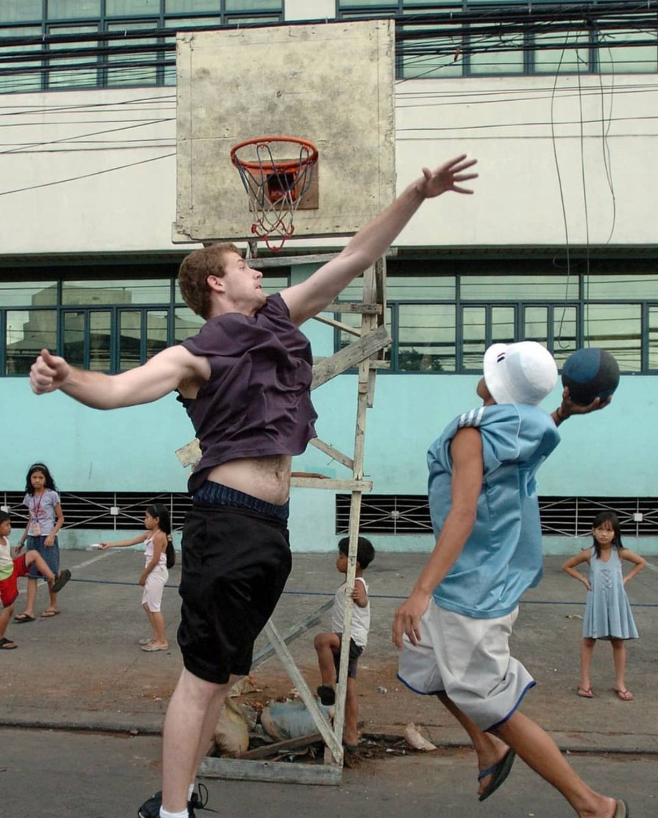 a white guy tries to block a filipino guy in a bucket hat's shot while a little girl looks on, hands on hips, unimpressed