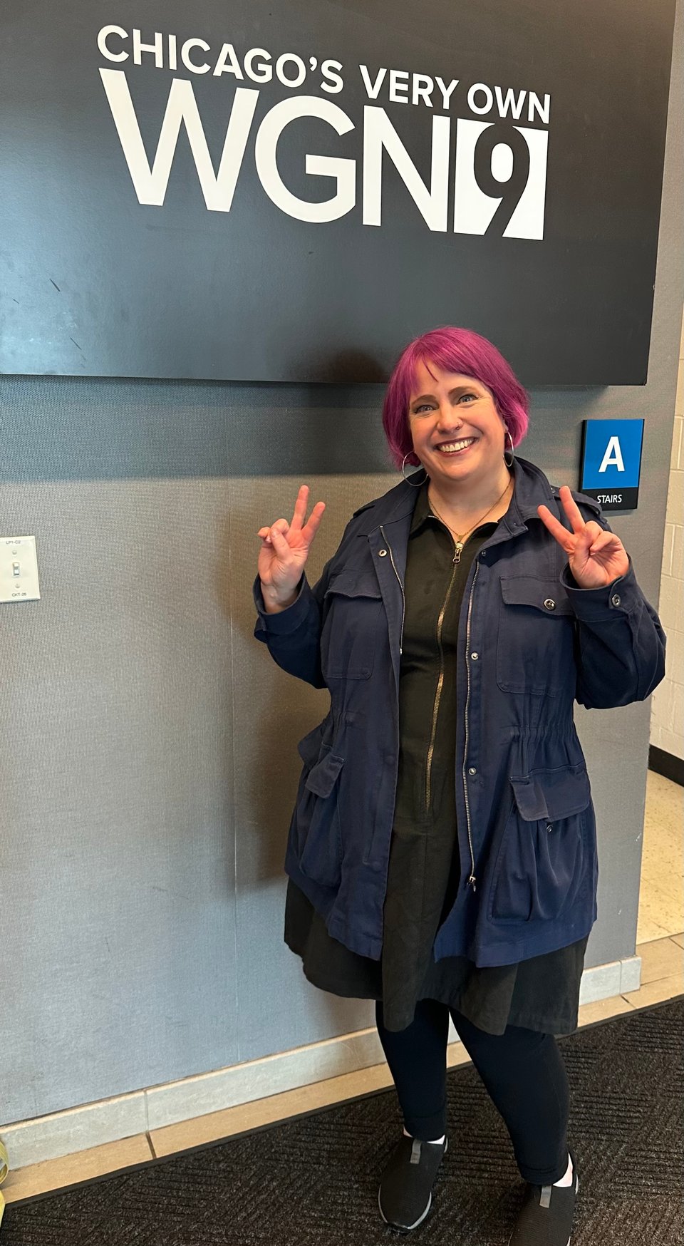 Yours truly posing under the "Chicago's Very Own WGN" sign