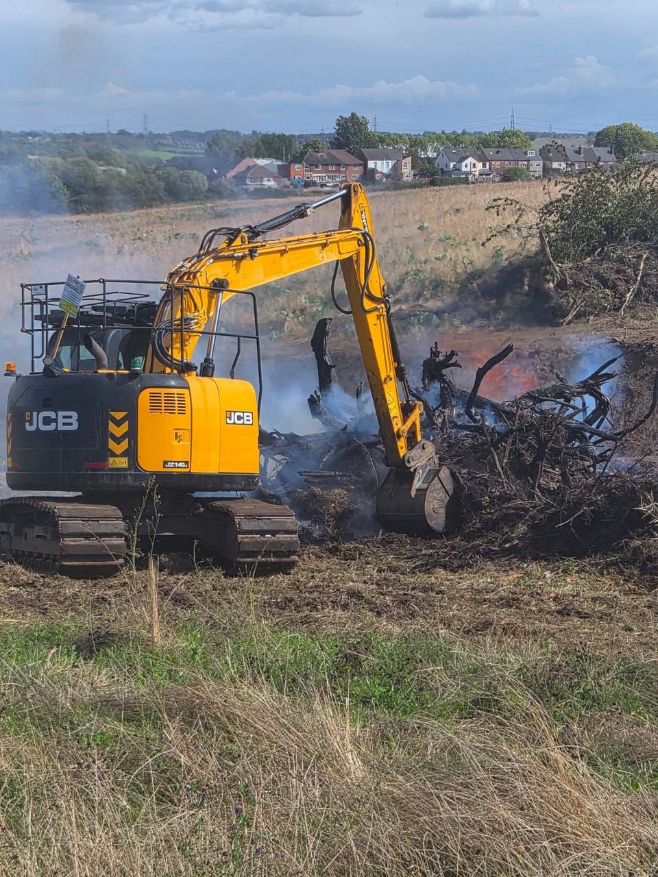 Uprooted trees and shrubs being burned beside the JCB (8 Sept 2026)
