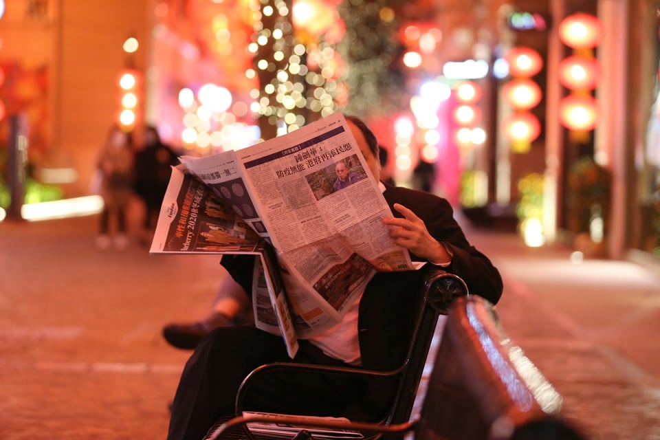 A stack of
folded-up newspapers, arranged side-by-side. Photo by Jonathan Gong on Unsplash.