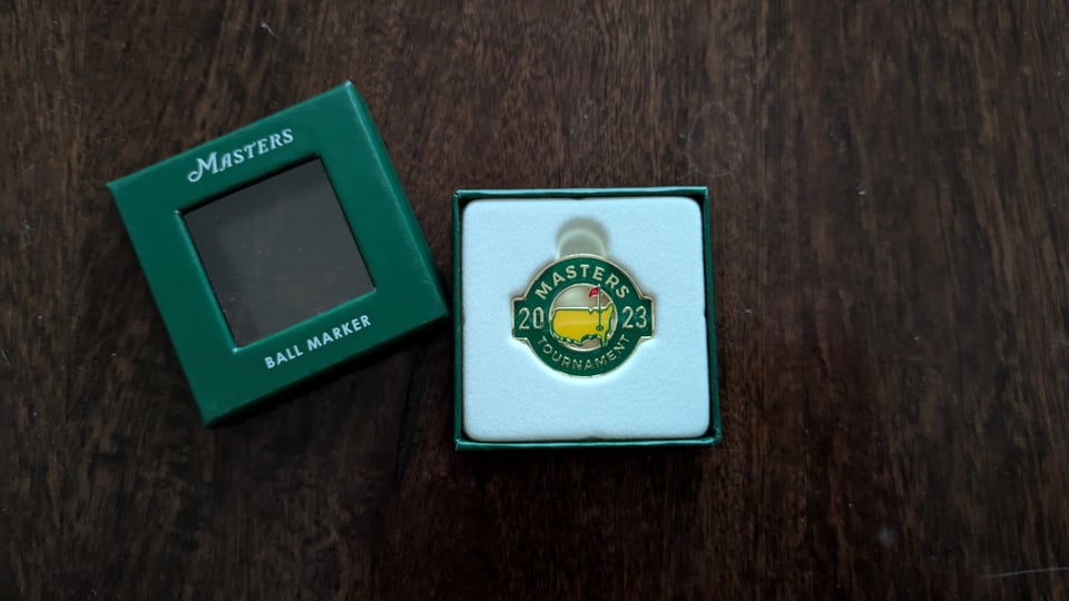 Green, yellow, gold Masters tournament ball marker in green presentation box