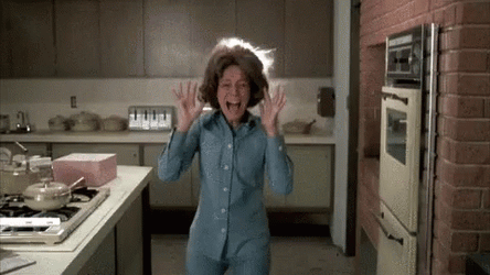 A GIF of a woman's hair exploding on fire.