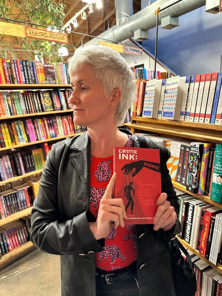 Me at Book Soup in LA holding a copy of Crime Ink: Iconic