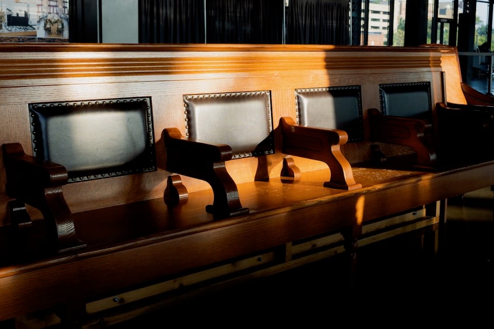Wooden train station bench in sunlight