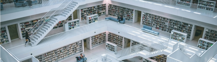 Multiple levels of floors, staircases, and bookshelves in a library