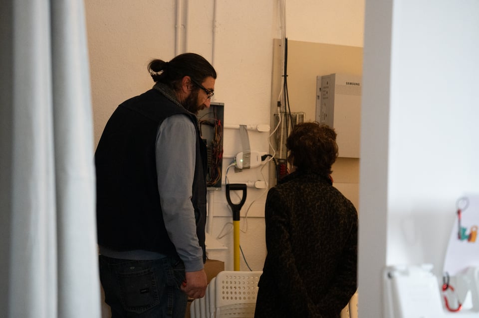 An electrician talking with a landlord.