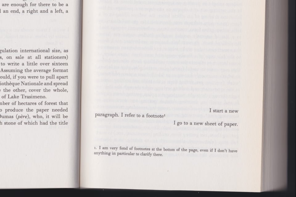 [A mostly blank book page with three staggered lines near the end and a single footnote.]
