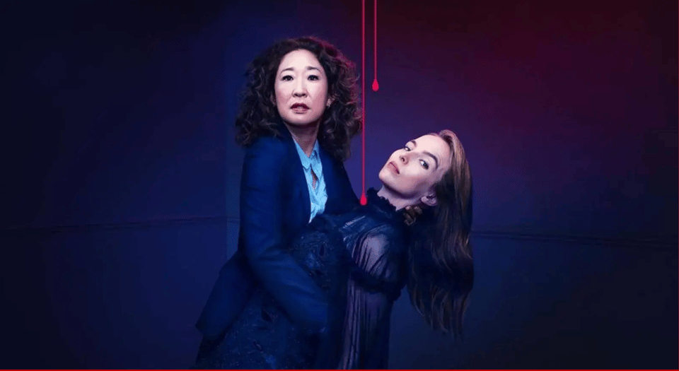 Against a dark blue background streaked with blood, Eve holds Villanelle at the waist as Villanelle arches backwards. Both women stare at the camera, unsmiling