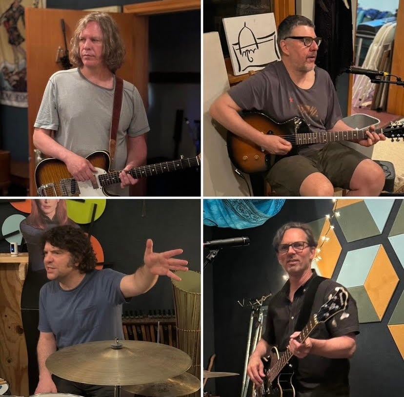 A composite 2x2 photo grid. Top left, a man with chin length brown hair holds a Telecaster-style guitar. Top right, A man with short hair and glasses sits while he plays an electric guitar resting in his lap. Bottom left, a man with shaggy hair sitting behind a cymbal looks to his right while gesturing with his left hand. Bottom right, a man with glasses plays a bass guitar while looking toward the camera.