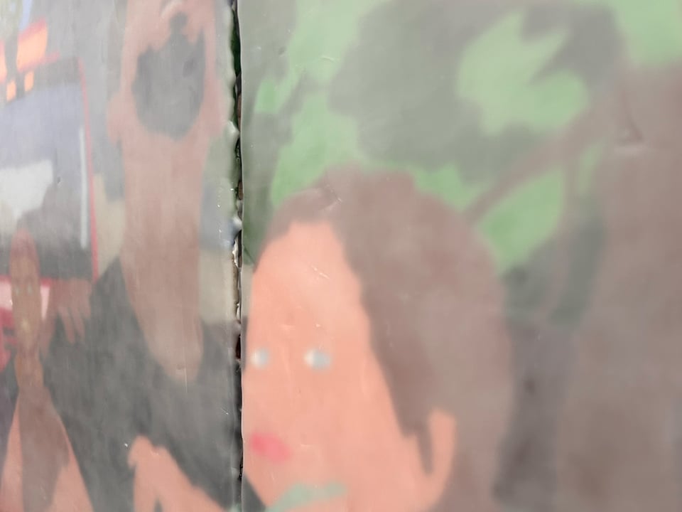 Closeup of large painting in two pieces. Close-up of a young child's face and a man, possibly her father.