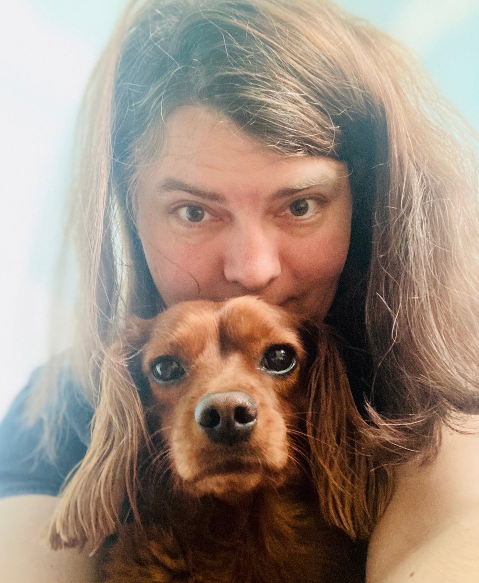 A beautiful woman and a cute dog.