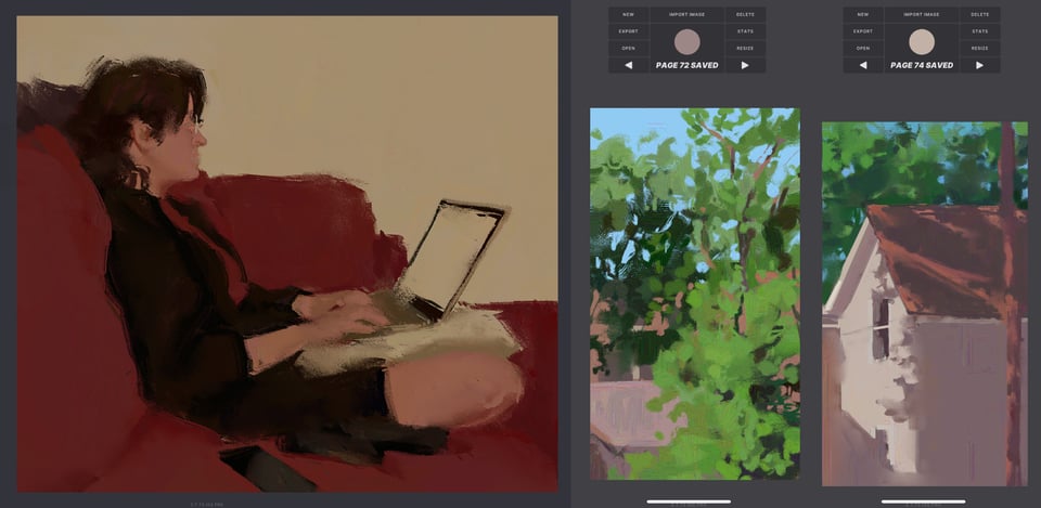 A person with dark hair wearing black shorts and a black sweatshirt over a red top, sits on a red couch with a pillow and laptop on their lap. Two paintings of trees and then houses submerged in tree, sunshine, and shadow sit next to it.