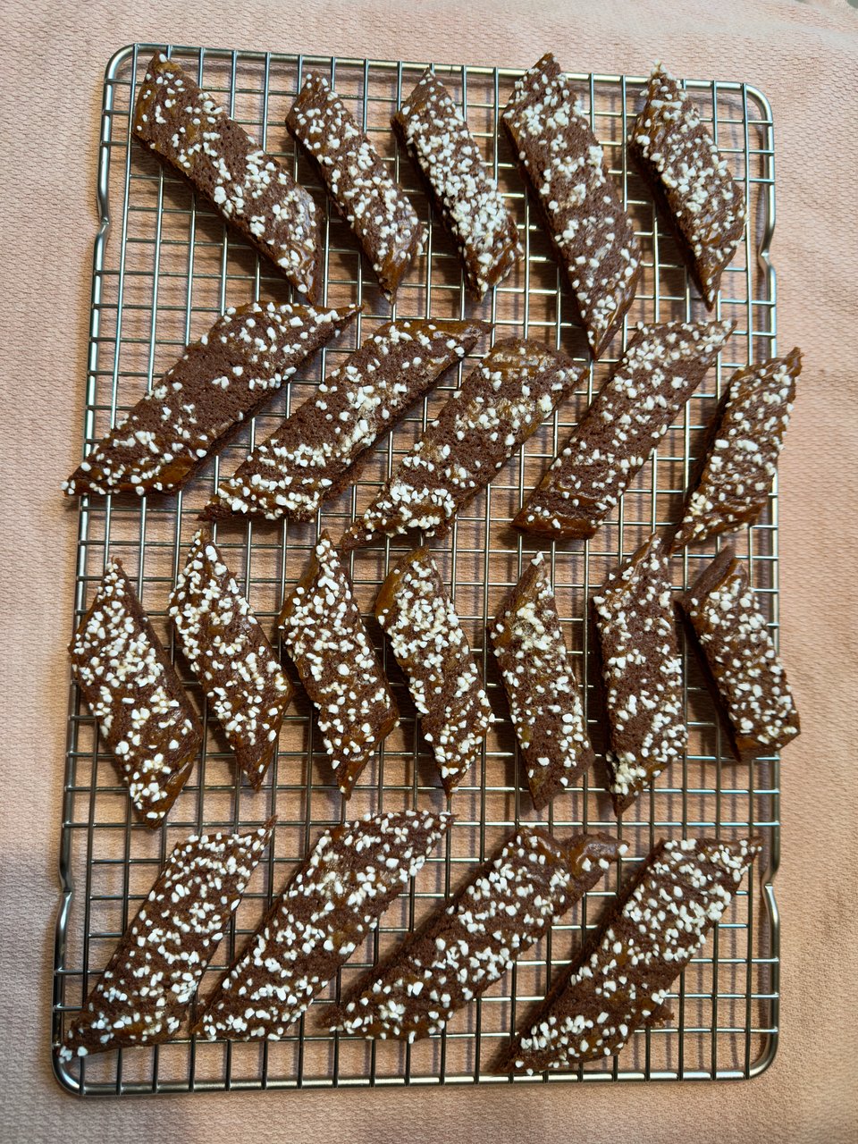 A batch of chocolate slices topped with pearl sugar on a baking sheet.