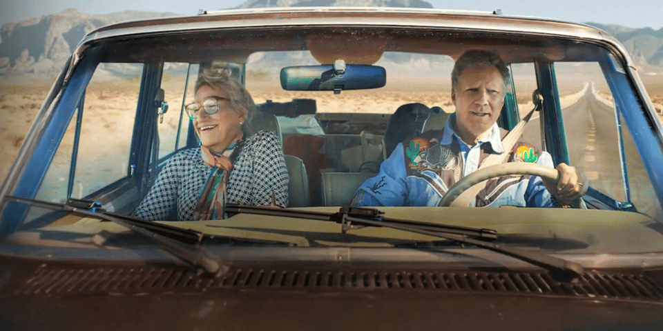 Will and Harper driving across the desert in a car.