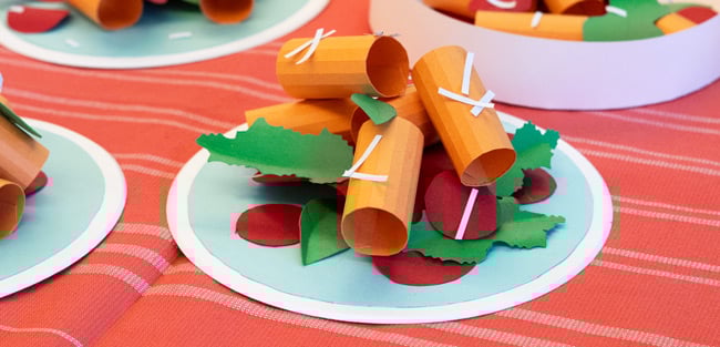 Plate of paper rigatoni with green leaves and red tomatoes