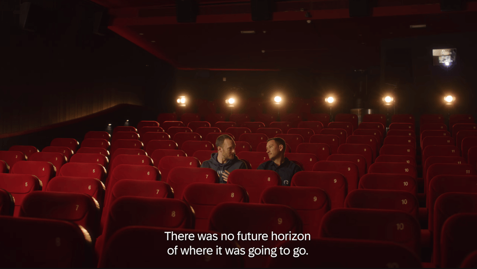 Victor and Steve in a movie theatre set watching (and filming) the new TL 25th Origins Documentary