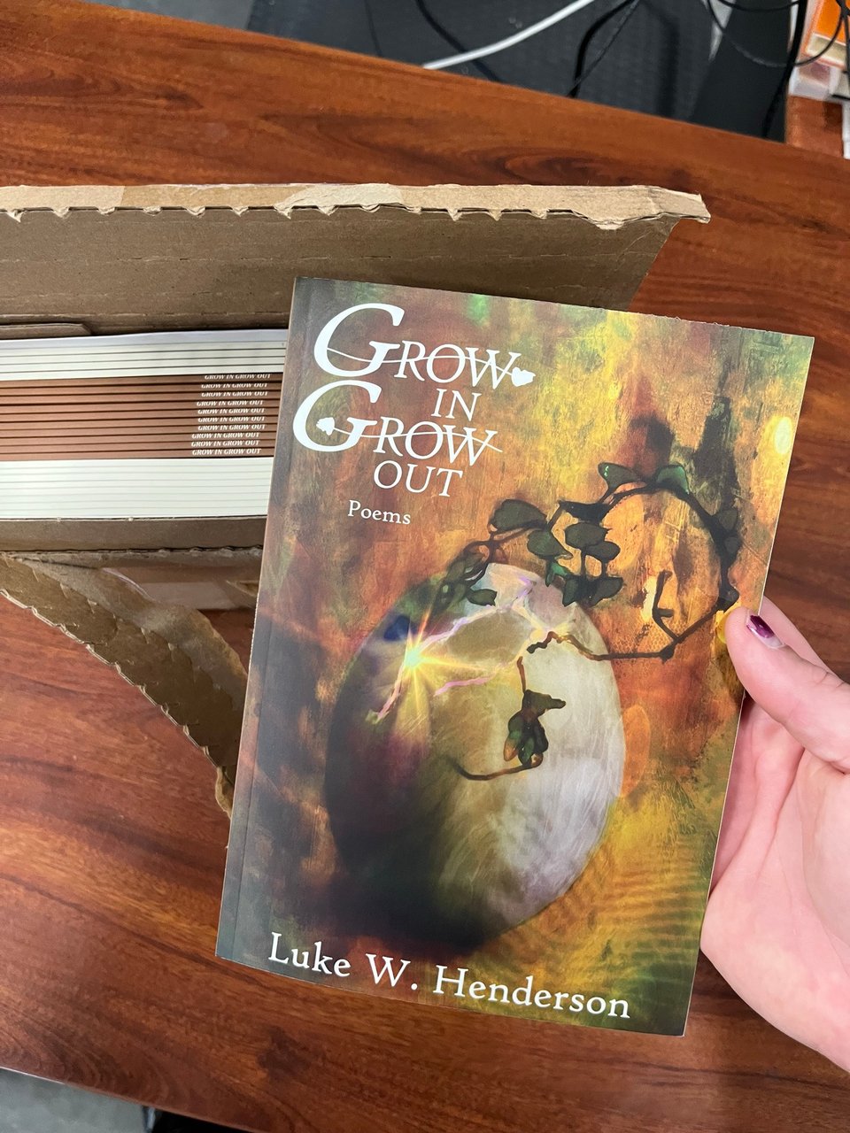 The box of books with one of them in my hand