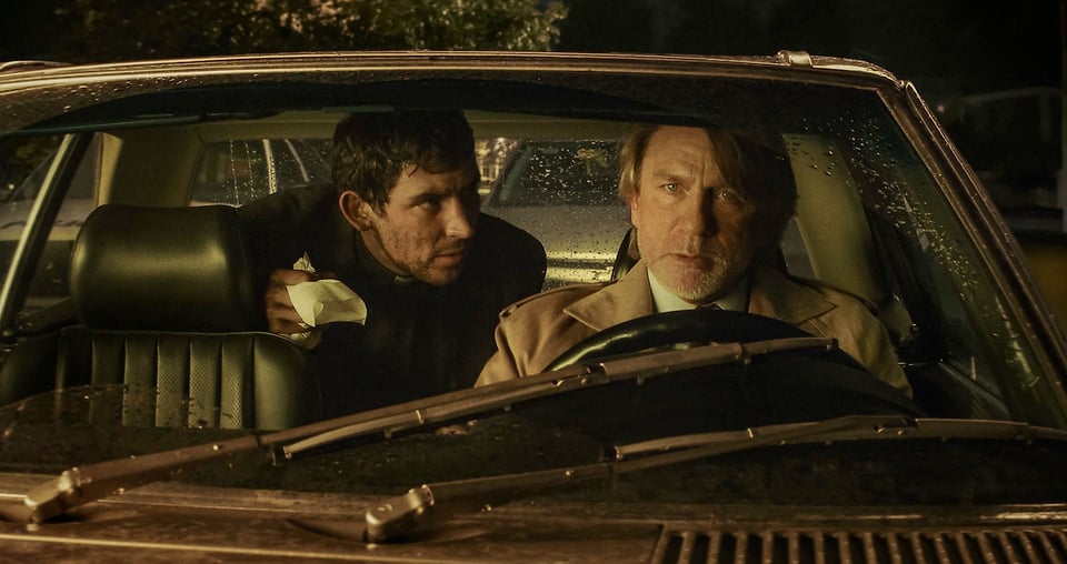 An image of Father Jud and Benoit Blanc being very dramatic in a car